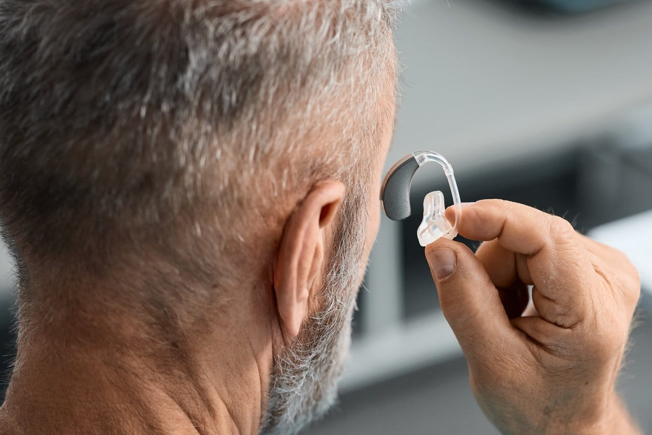 Man holding a hearing aid