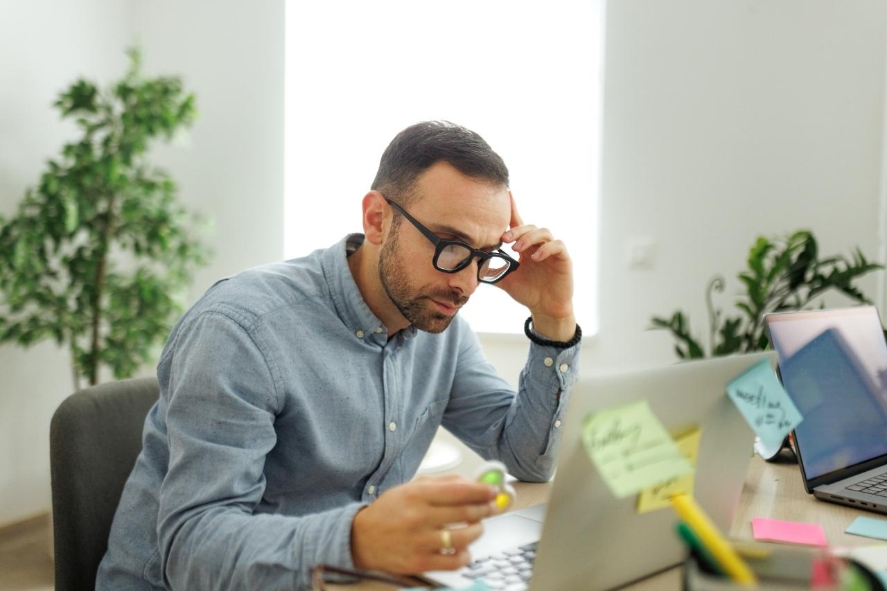 Man in glasses working on a computer