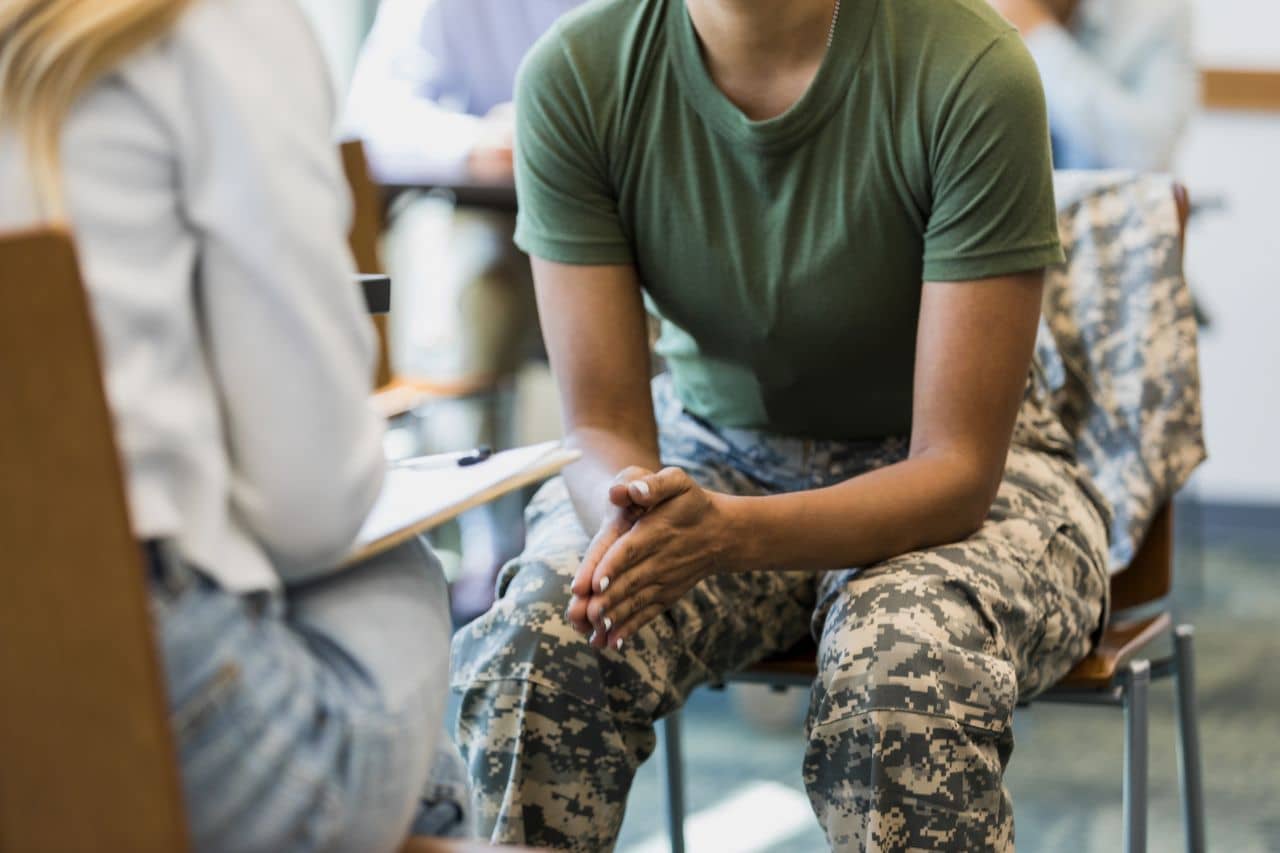 Woman in camo pants with a therapist