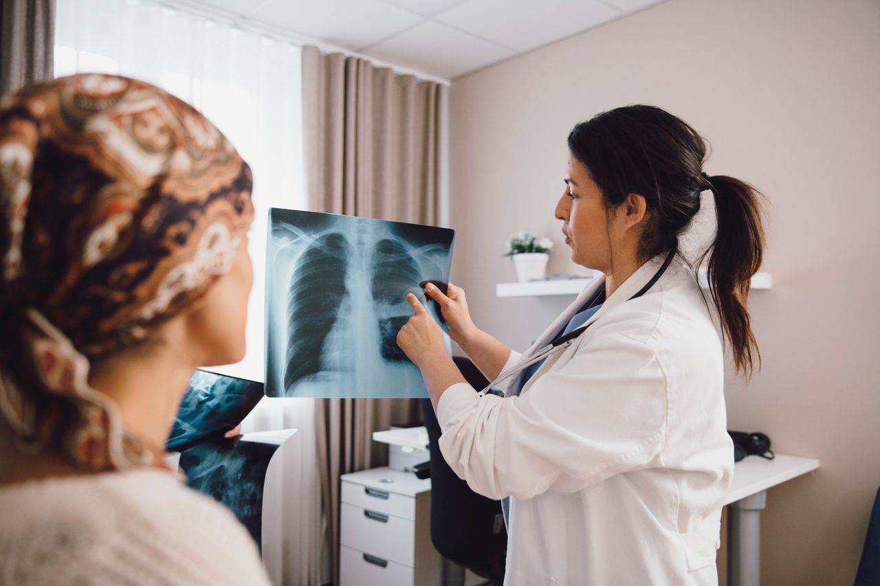 Doctor reviewing chest X-ray with patient.