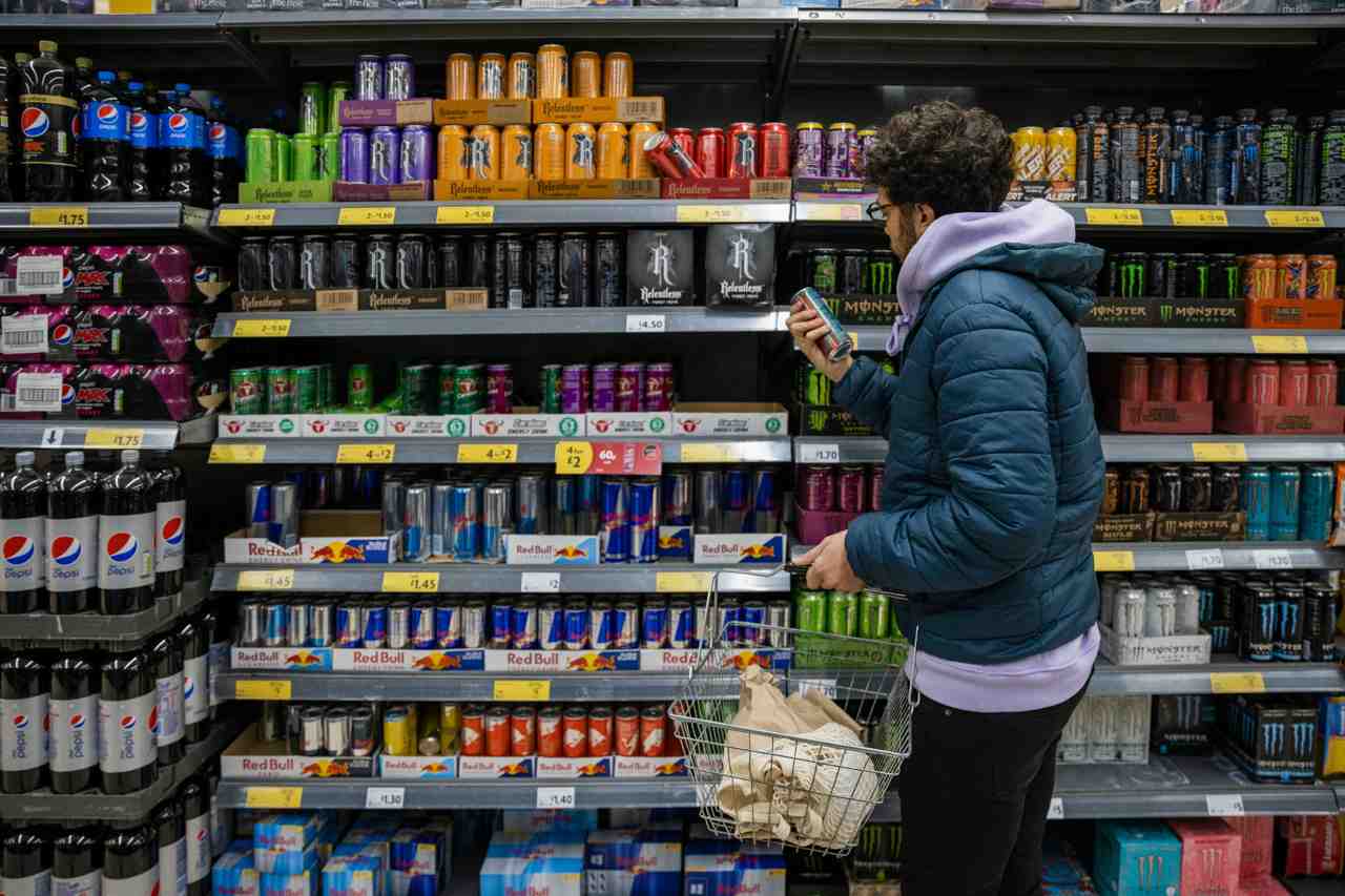 Man looking at a shelf of energy drinks