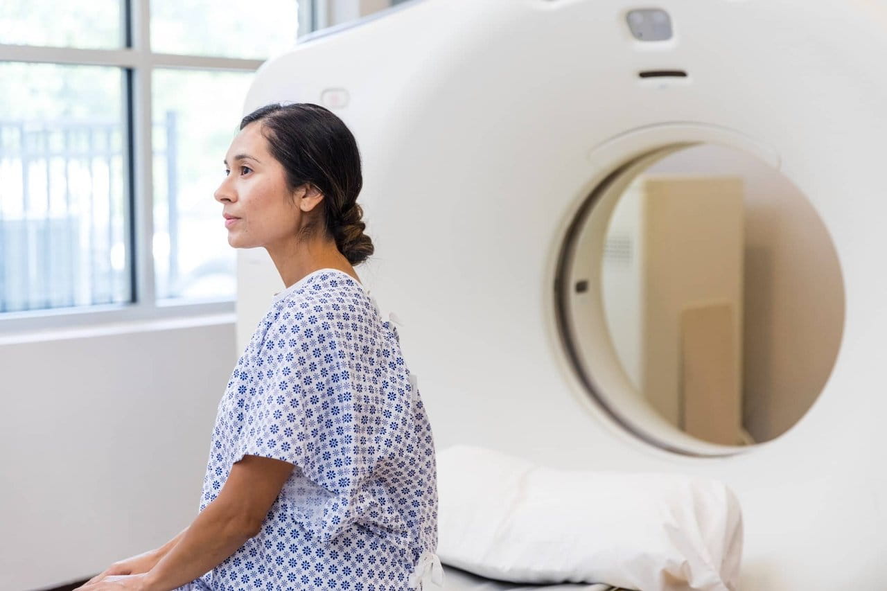 Patient sitting next to scan