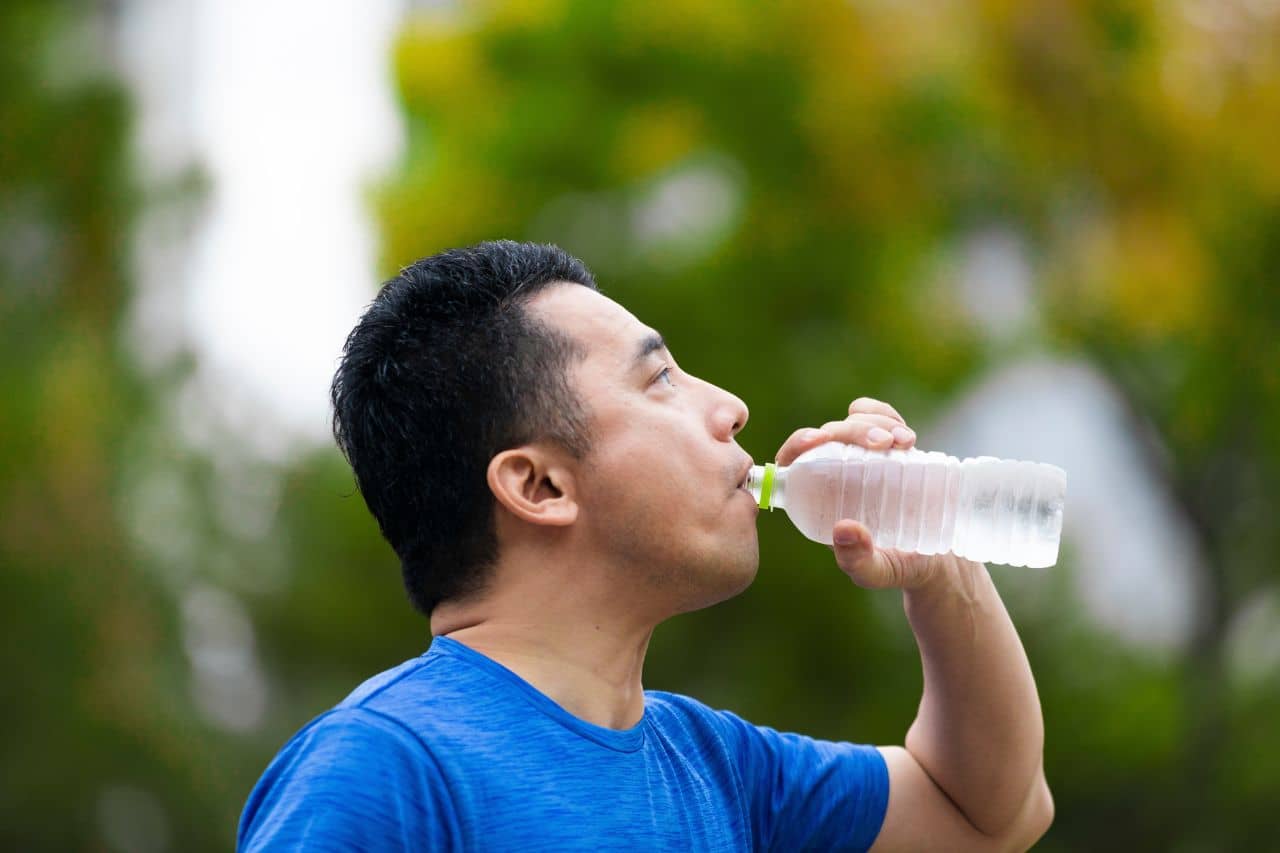Man drinking water in the sun