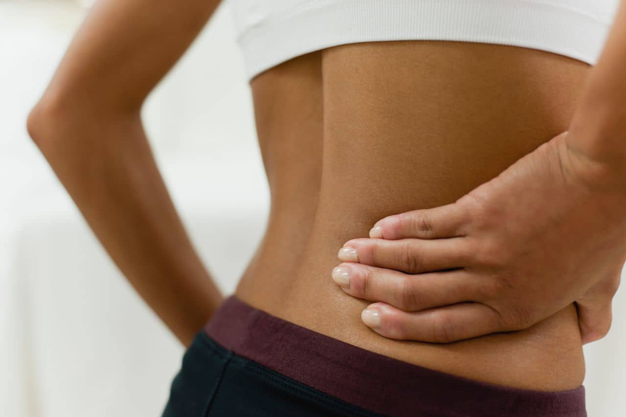 Woman holding her lower back