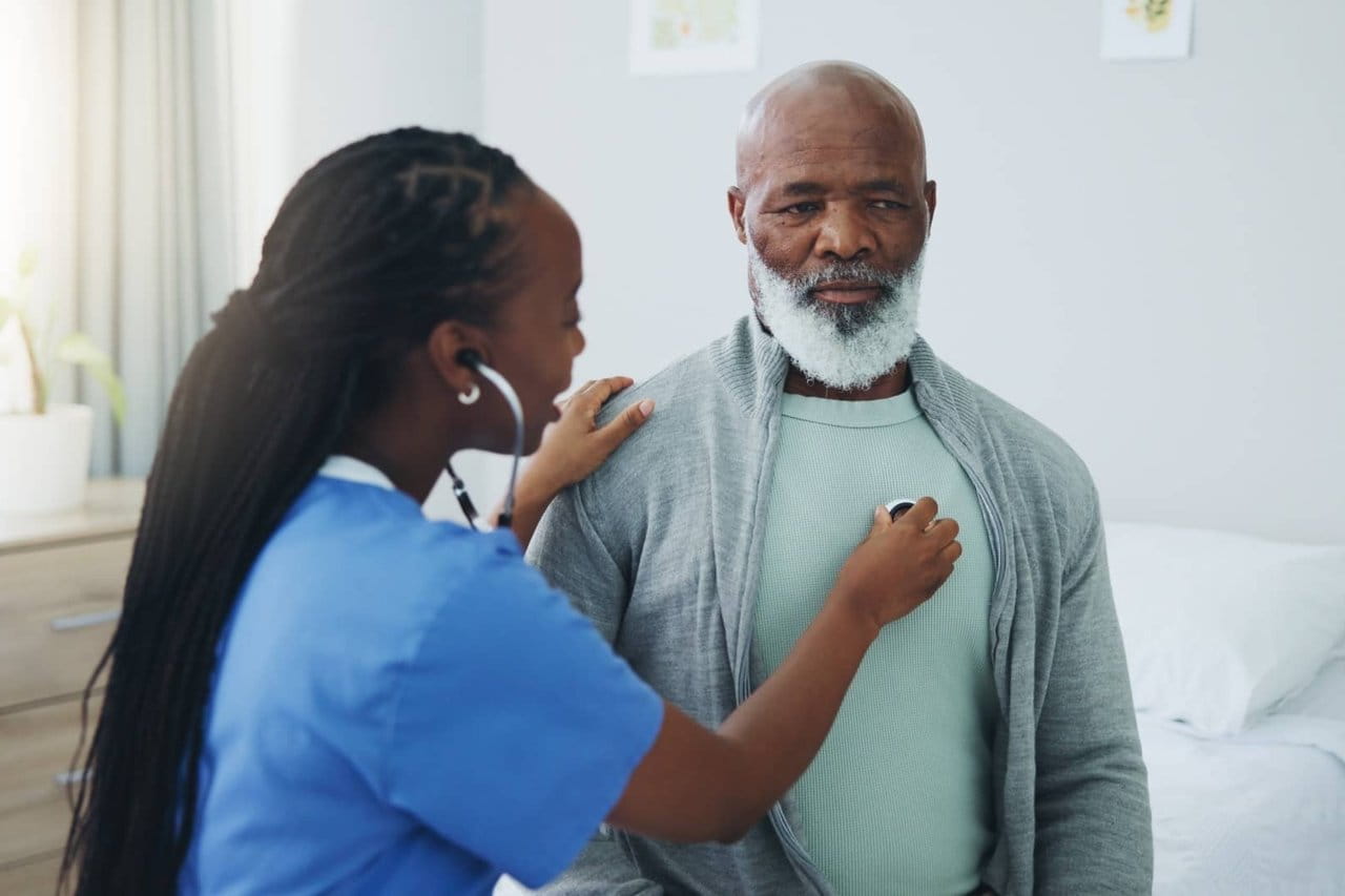 Nurse checking a man's lungs