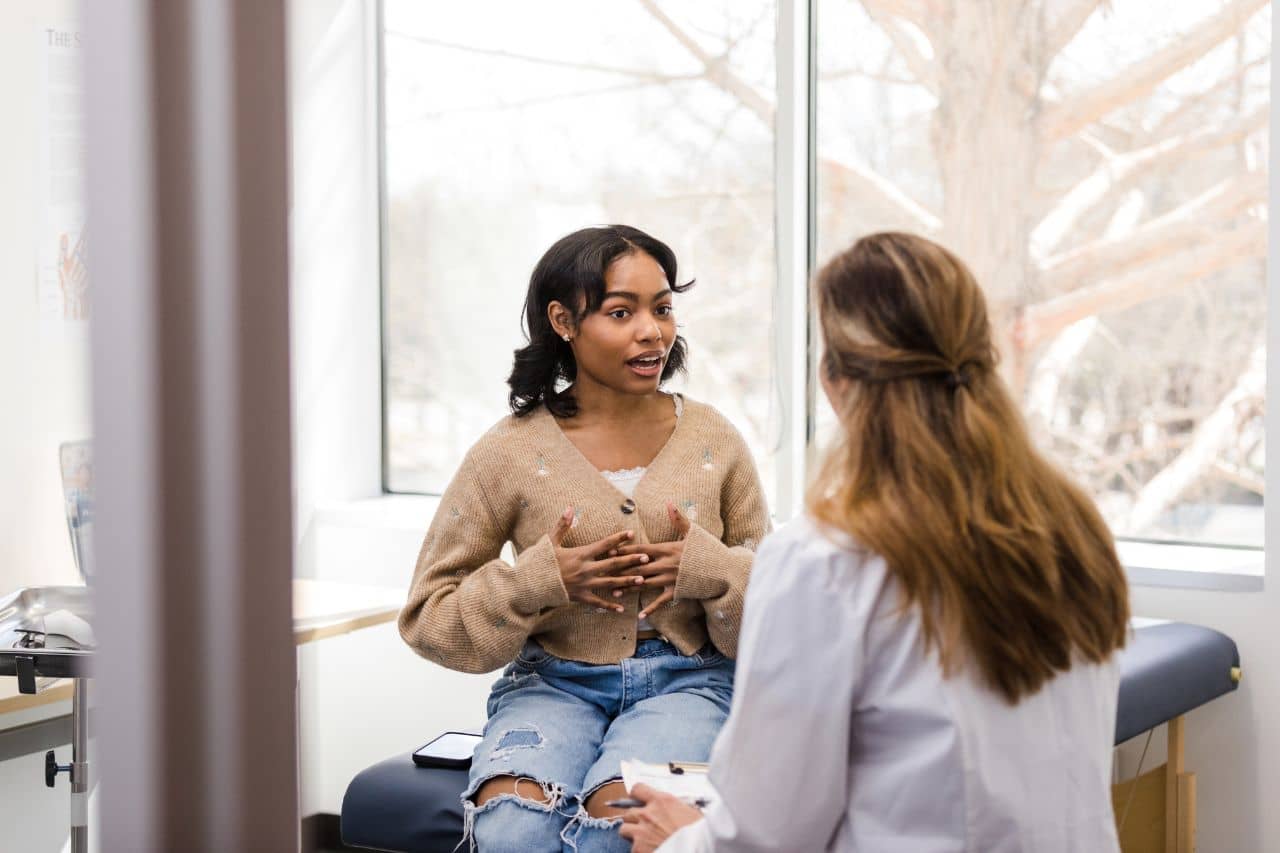 Young woman talking with a doctor