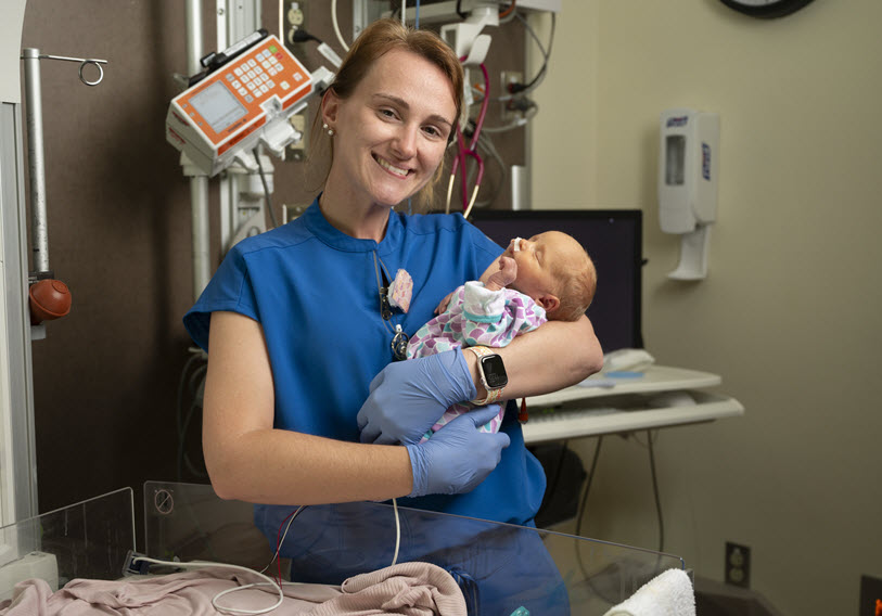 Smiling Nurse with Baby at Baptist Health Paducah