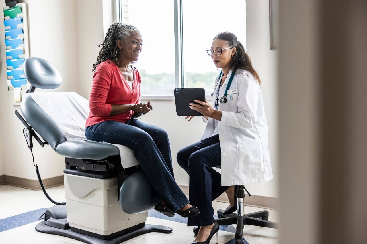African-American Woman speaking with a doctor