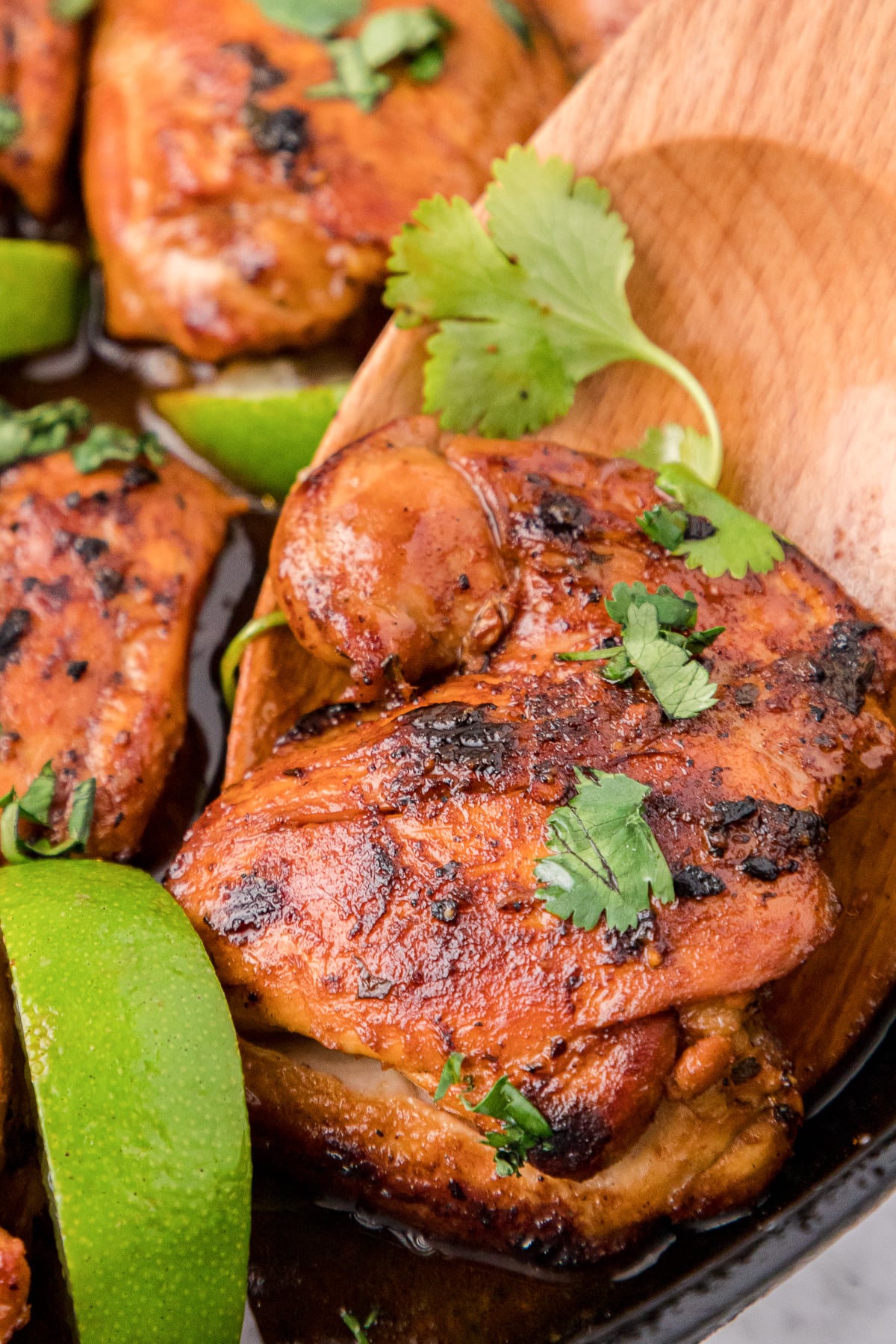 Cilantro lime chicken being scooped out of skillet.