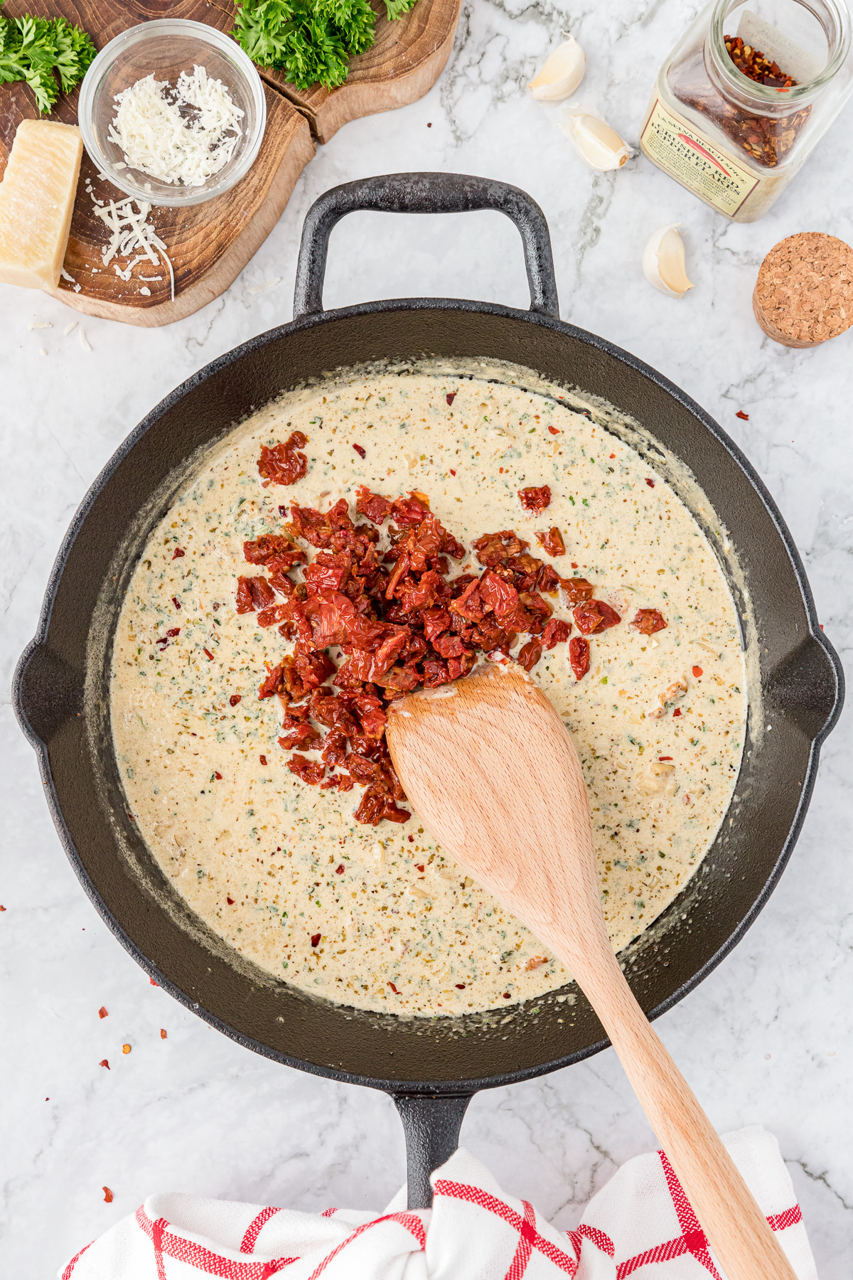 Cooking cream sauce in a skillet.