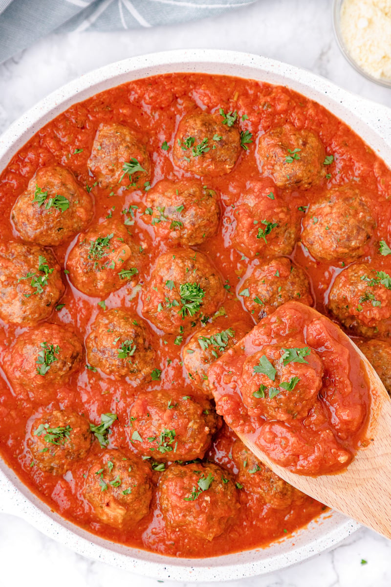 Meatballs in a pan with sauce.