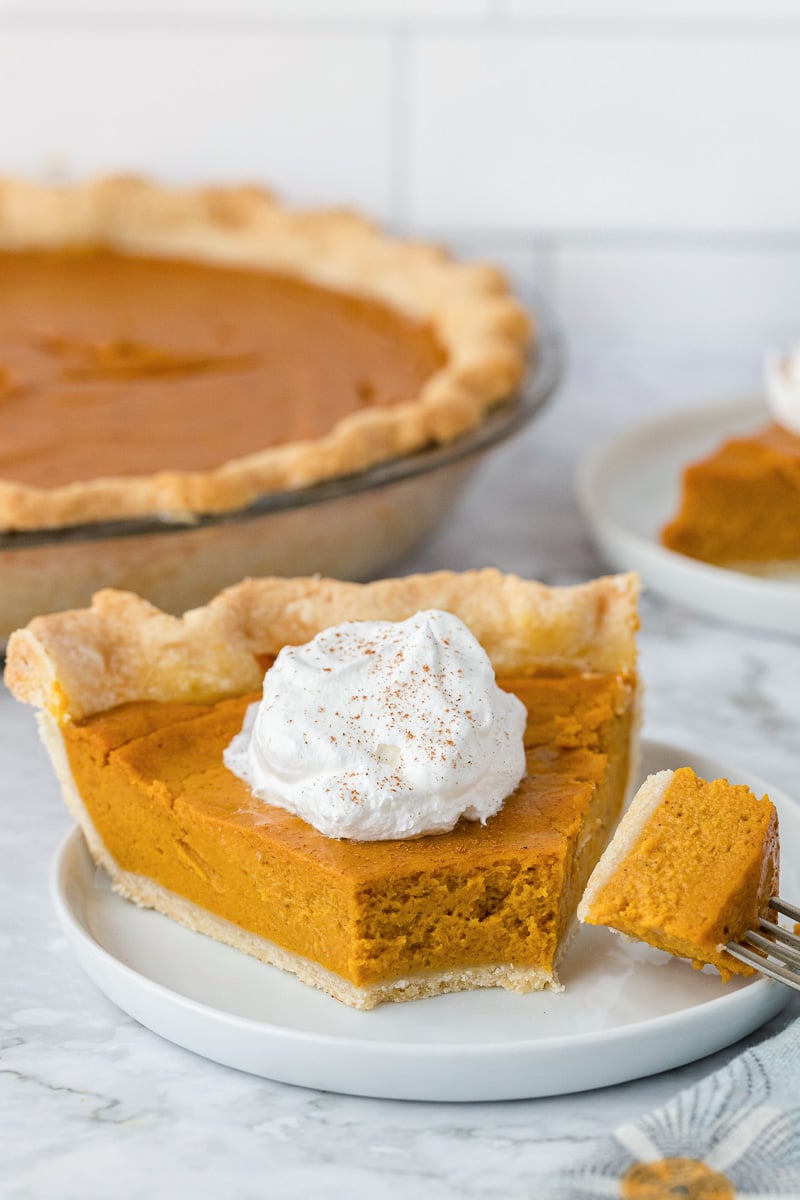 Sweet potato pie with fork taking a bite out.