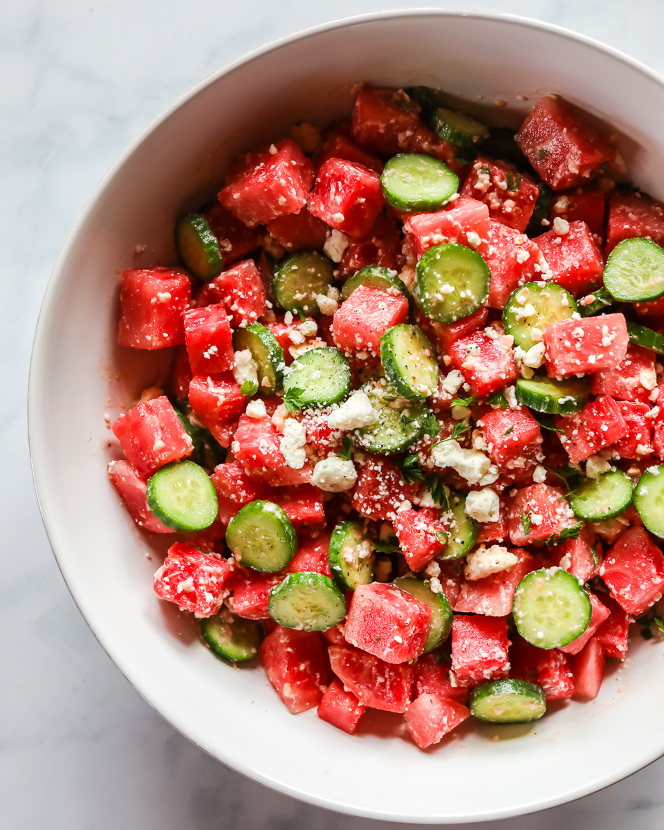 Watermelon salad in white bowl.