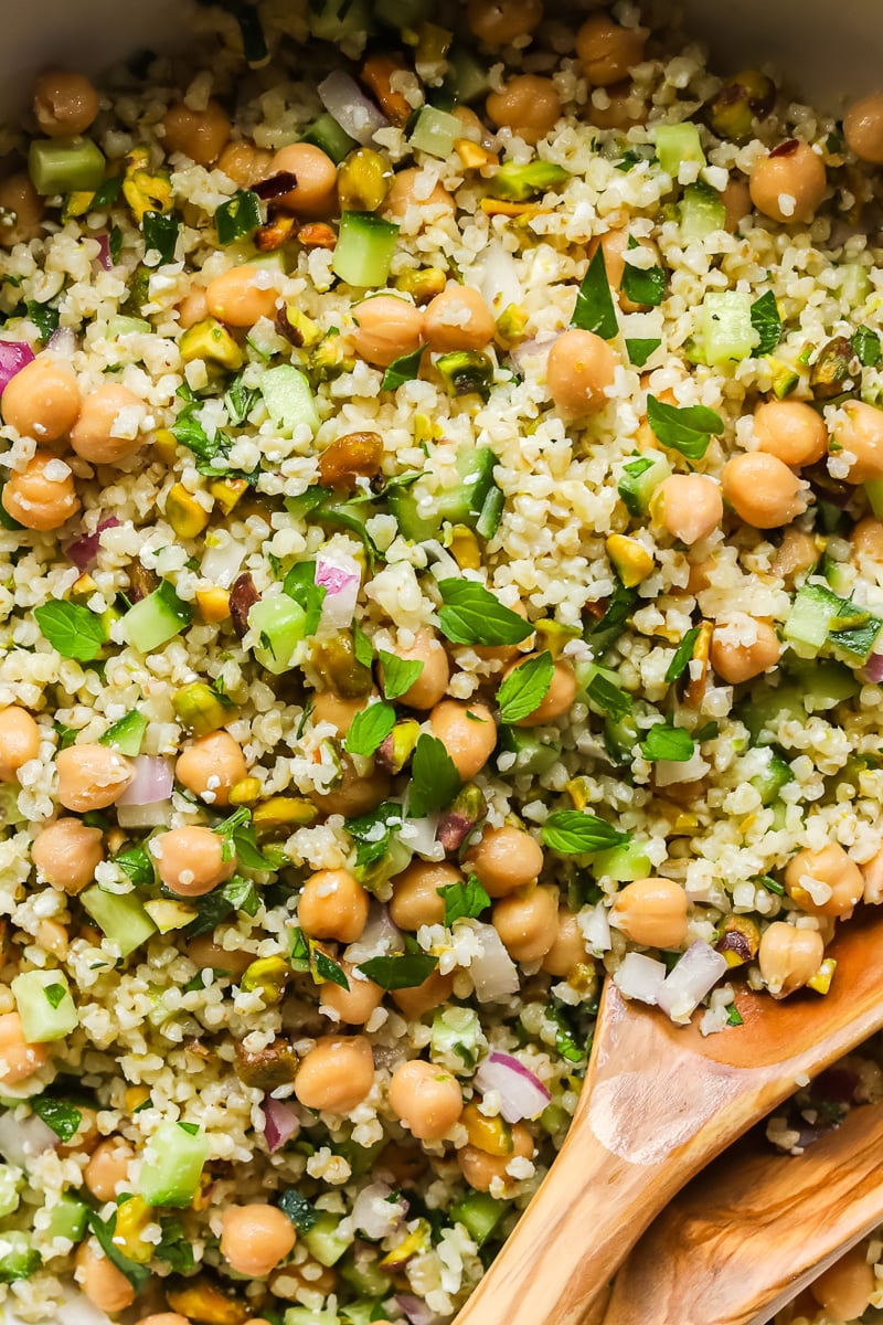Close up of Jennifer Aniston salad with wooden spoon.