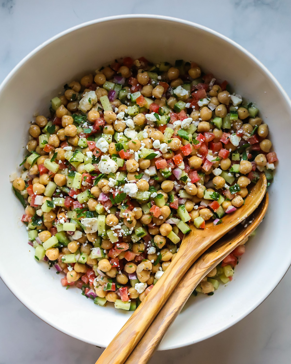 Chickpea salad in white bowl.