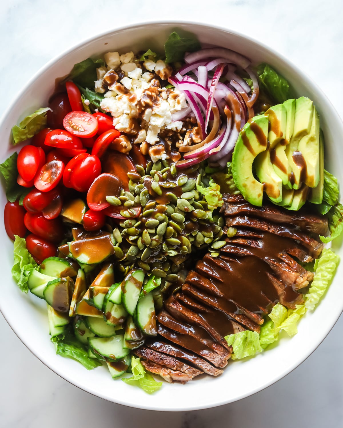 Steak salad with dressing.