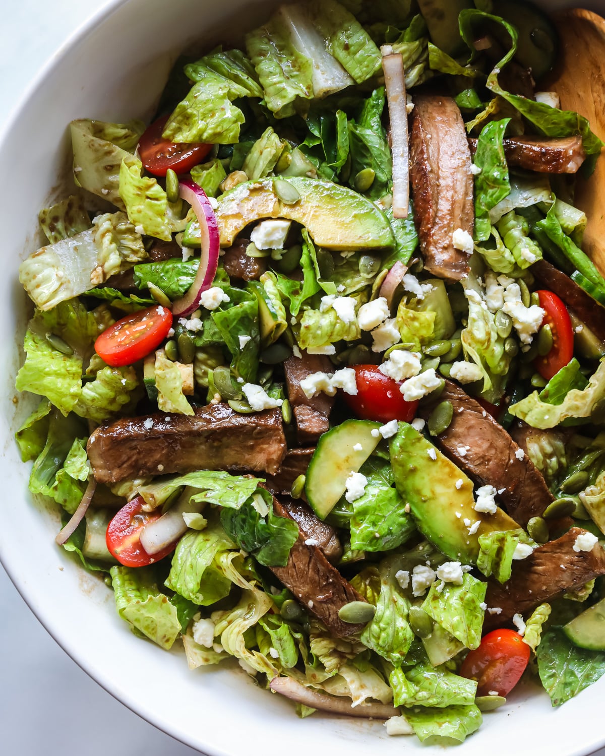 Steak salad in serving bowl.