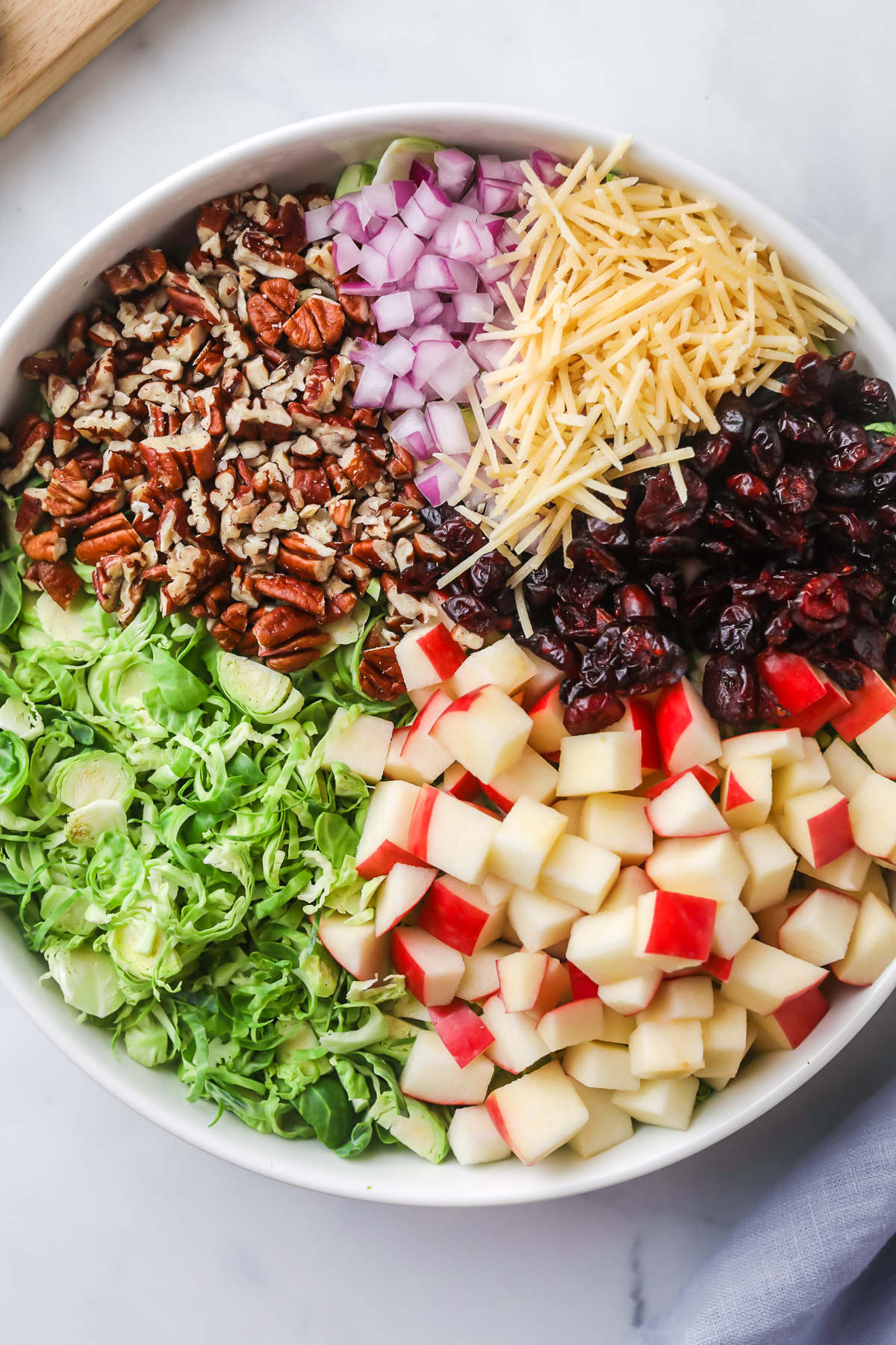 Ingredients for brussels sprouts salad in bowl.