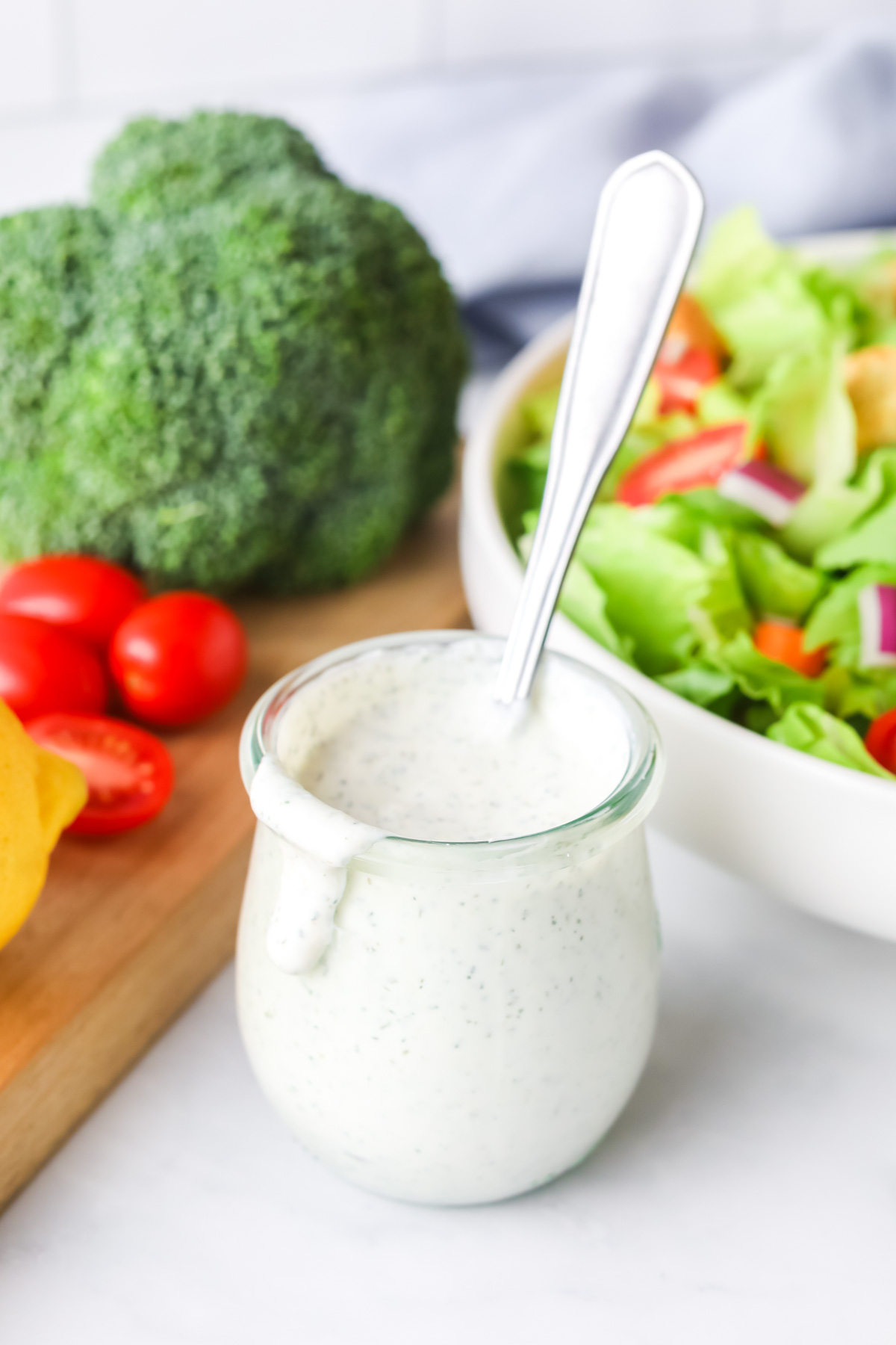 Ranch dressing in a jar with salad.