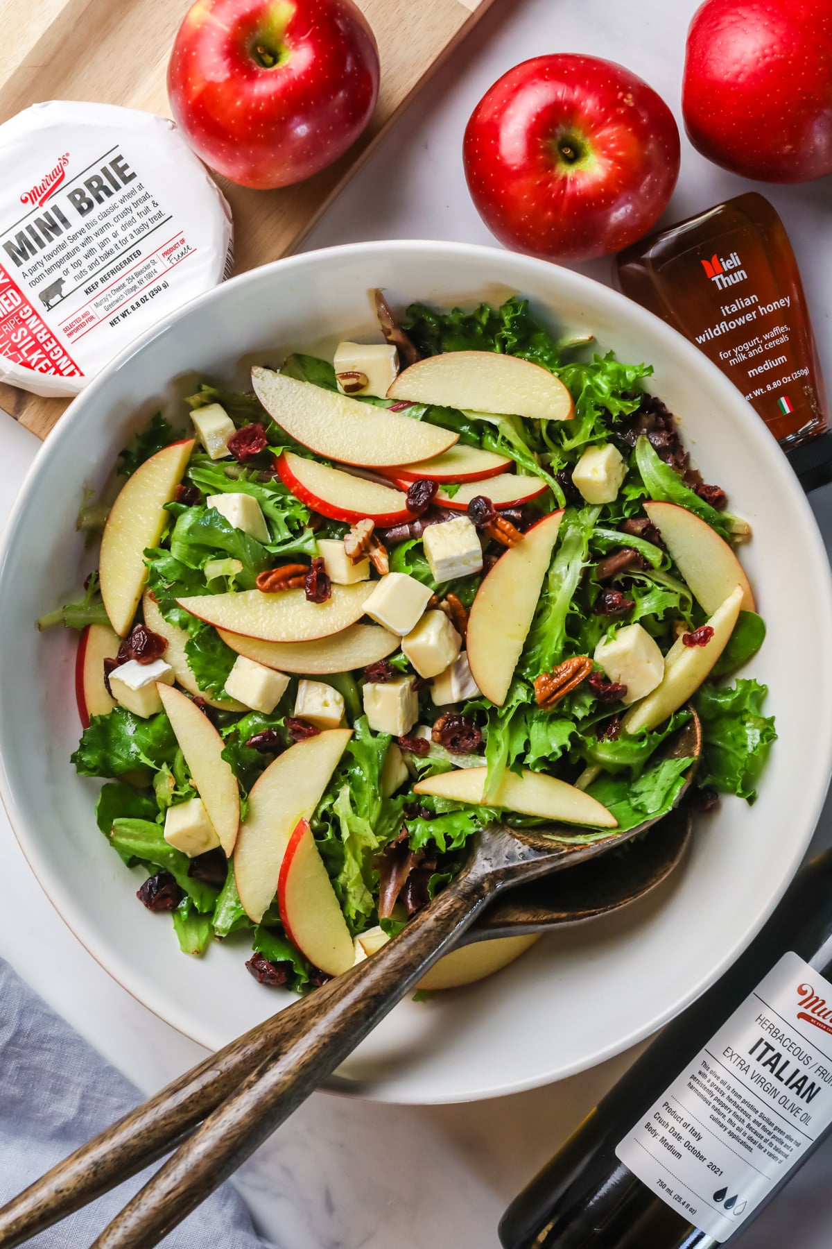 Apple brie salad in white bowl.