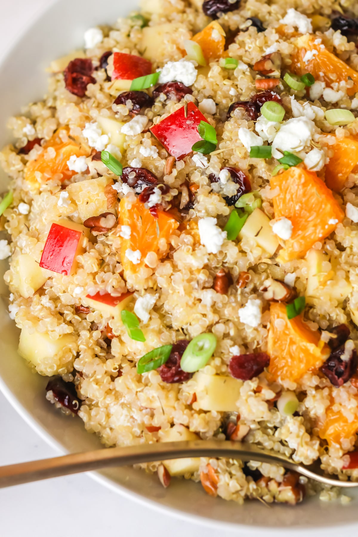 Fall quinoa salad in a white bowl.