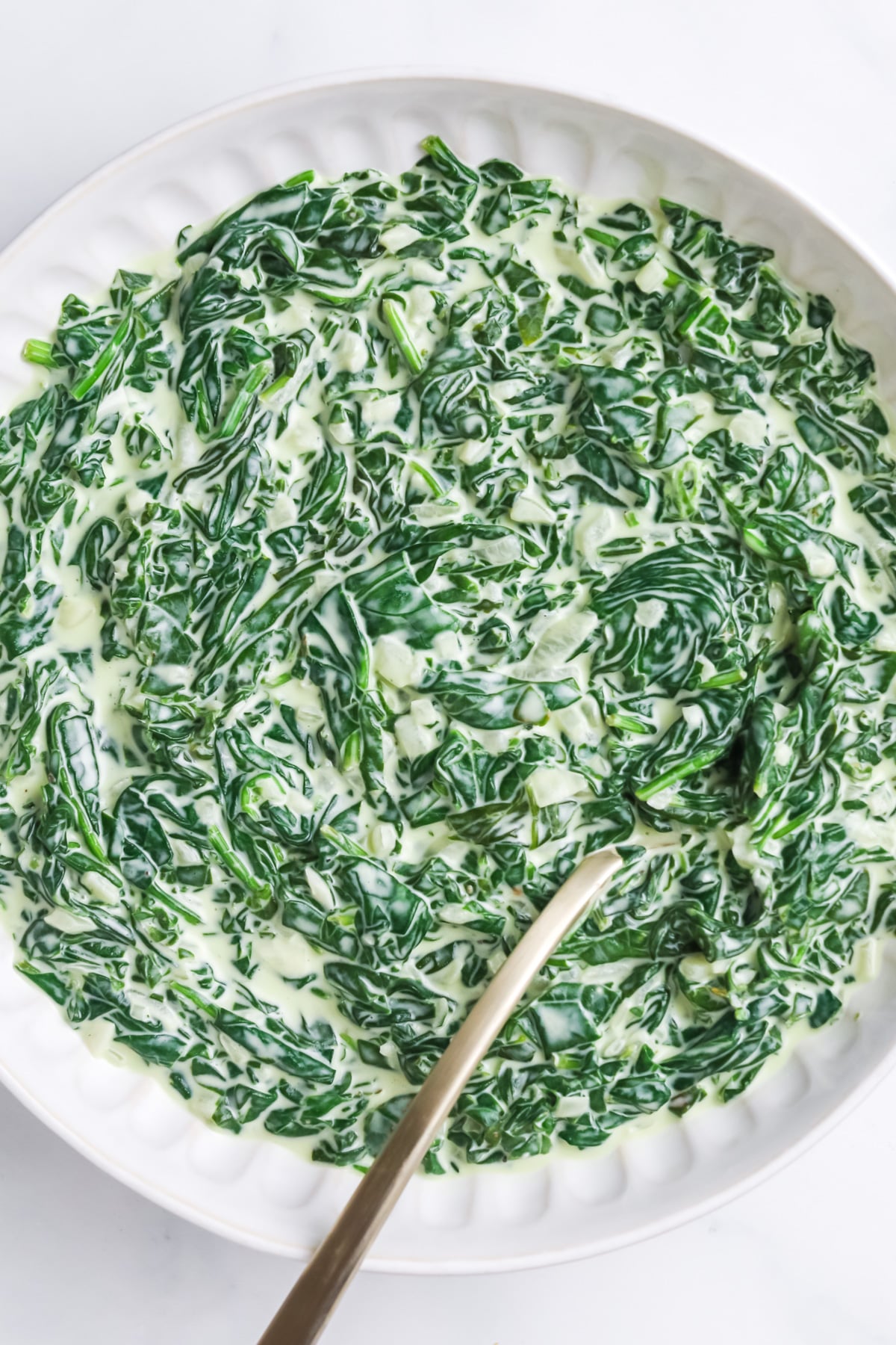 Easy creamed spinach in white bowl..