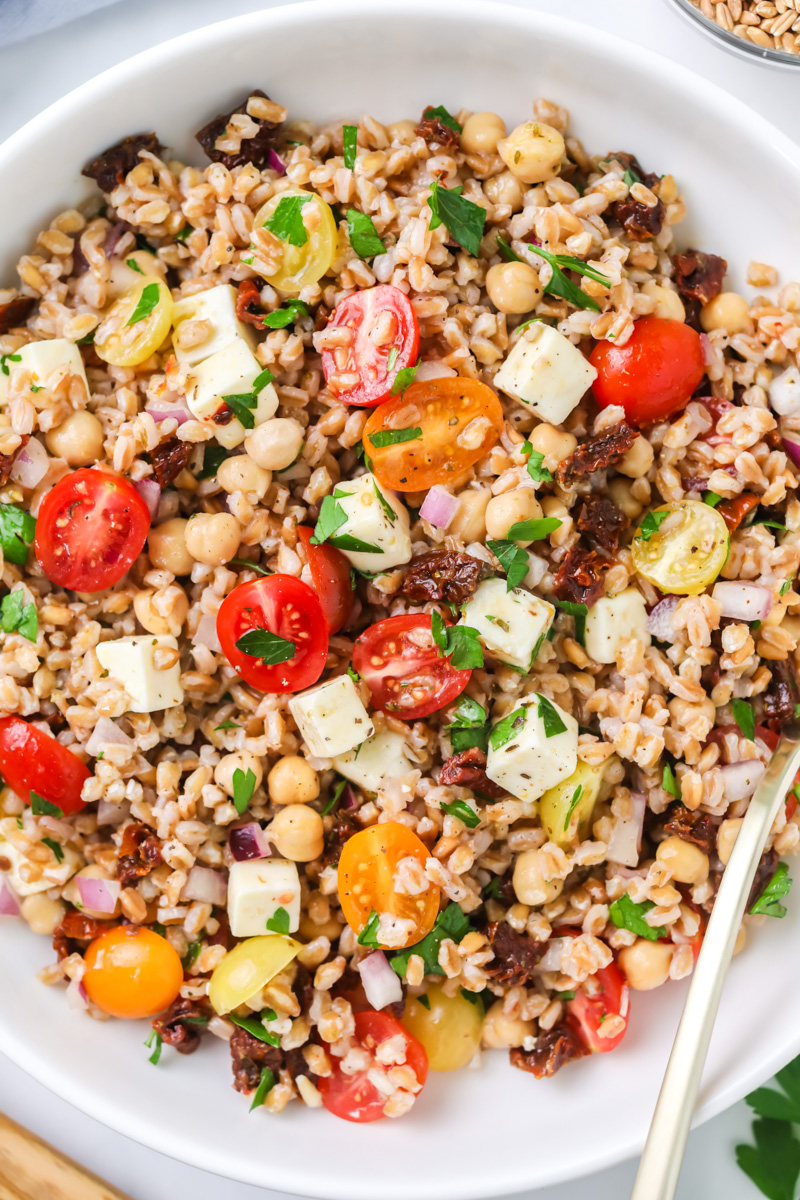 Farro salad in white bowl.