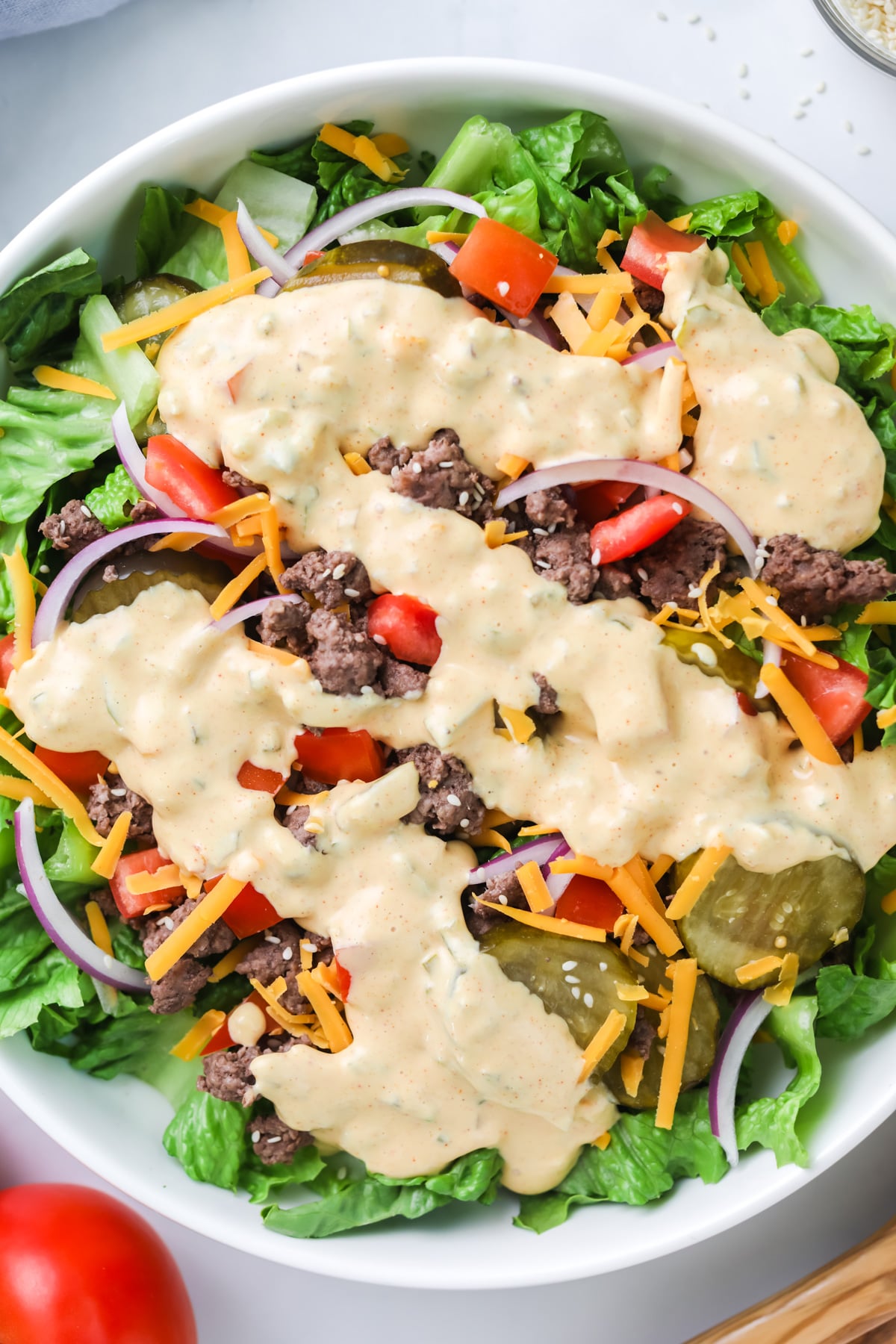 Big mac salad with dressing.