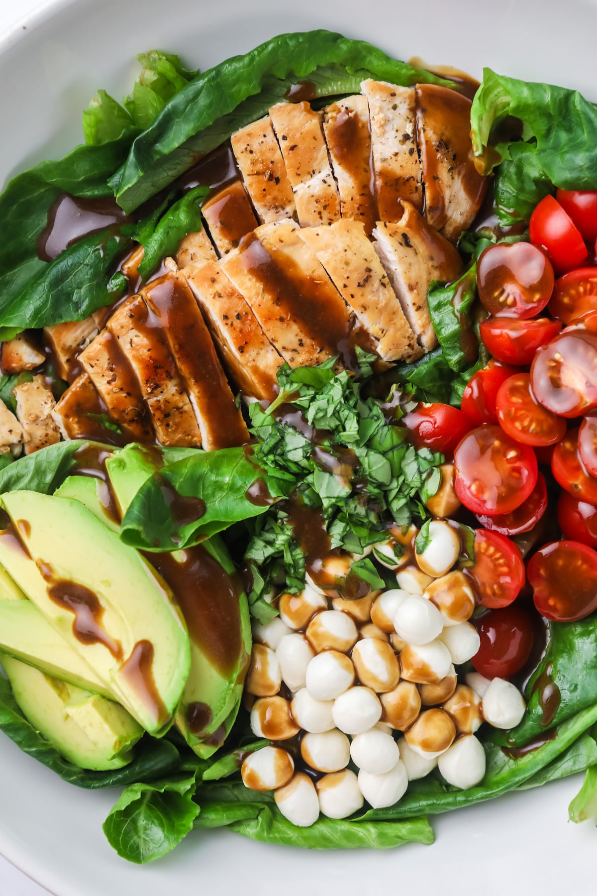 Chicken caprese salad with balsamic drizzle.