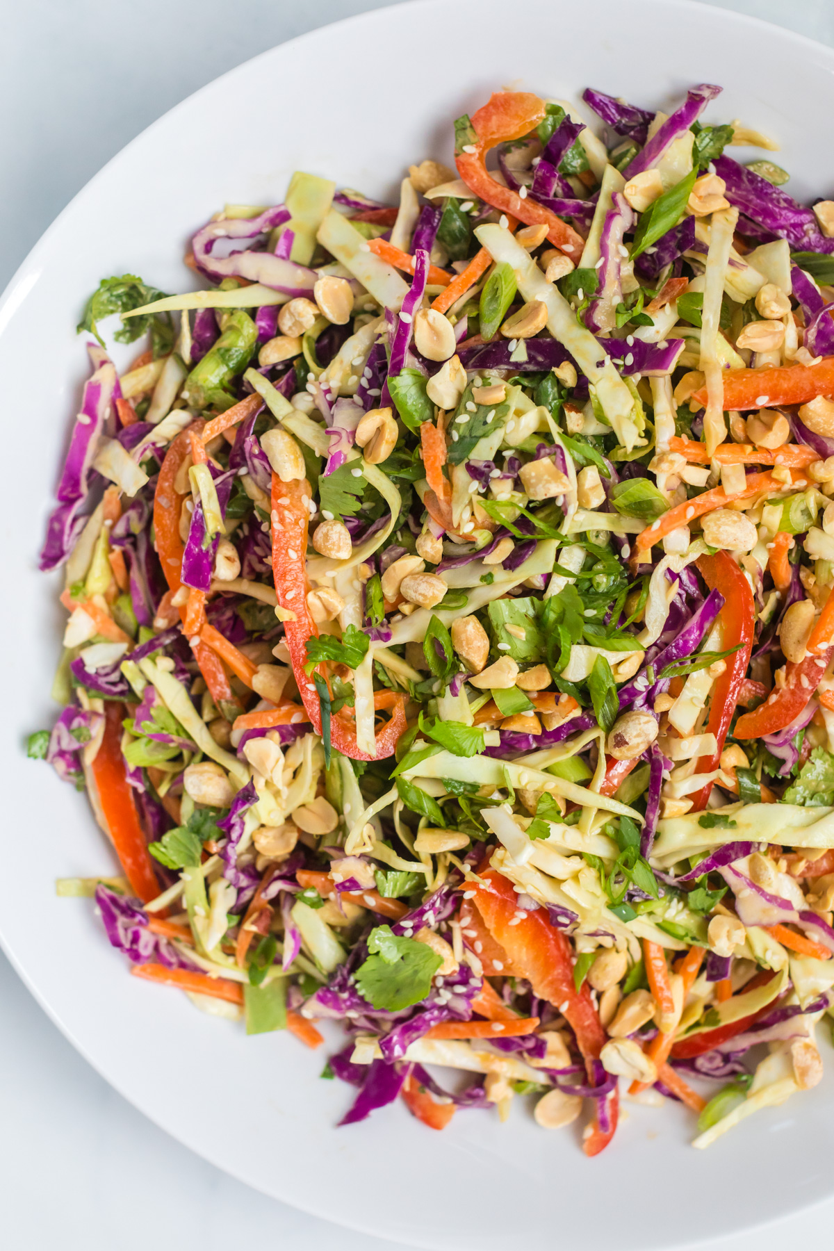 Cabbage salad in white bowl.