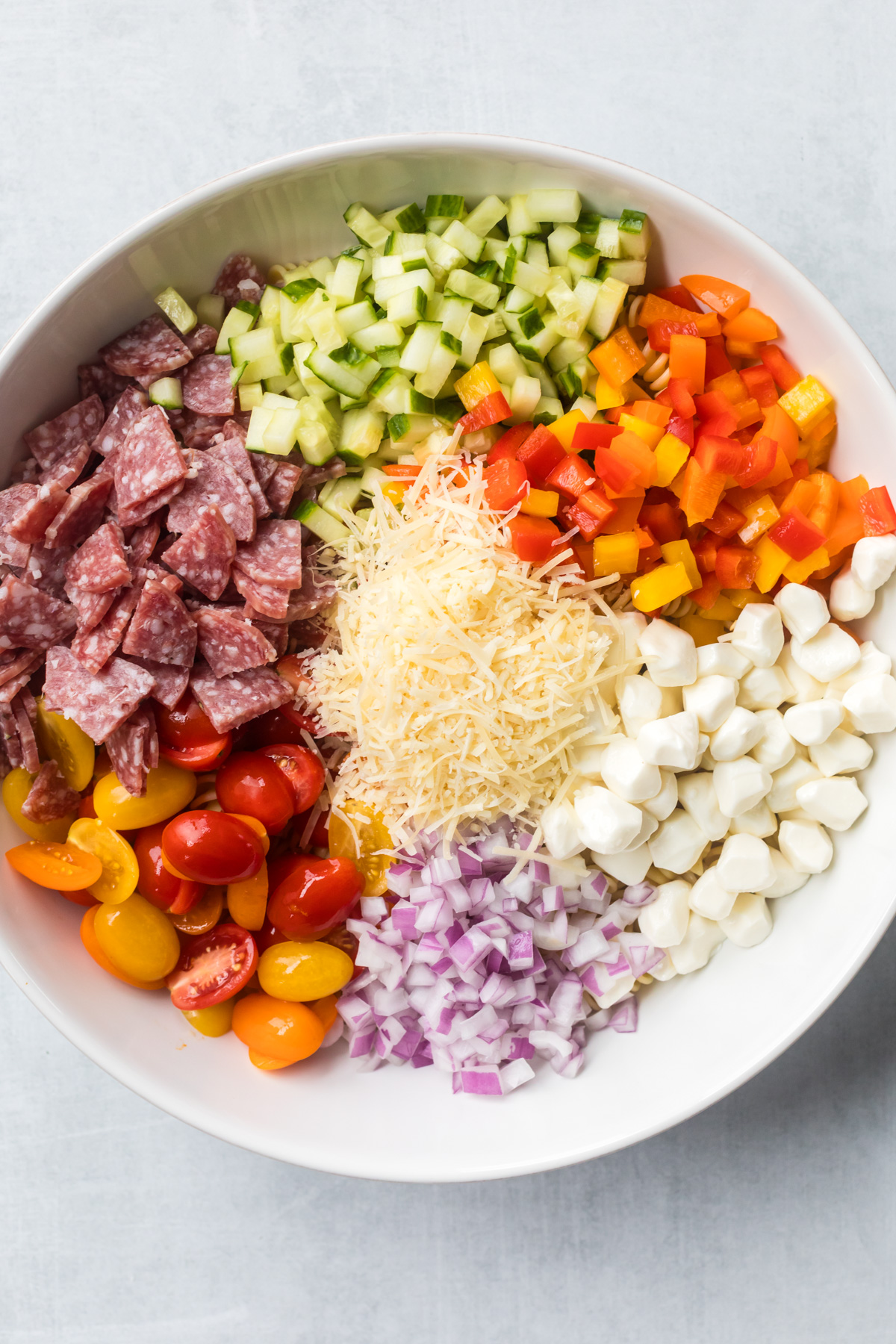 Pasta salad with salami ingredients ready to mix.