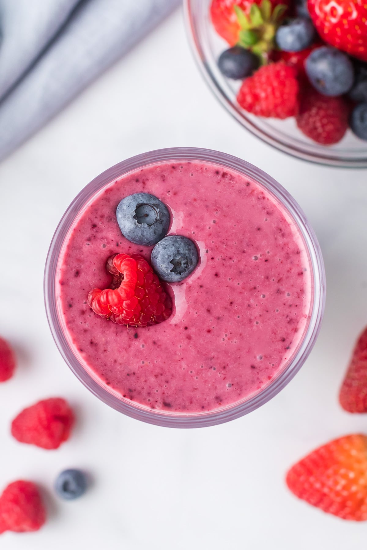 Kefir smoothie overhead with raspberry and blueberries.