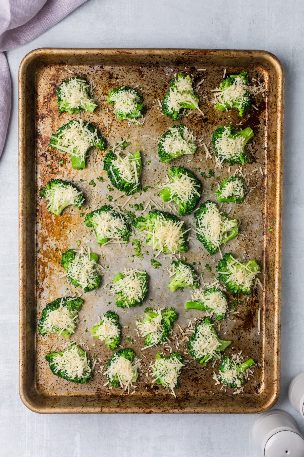 Smashed broccoli on pan.