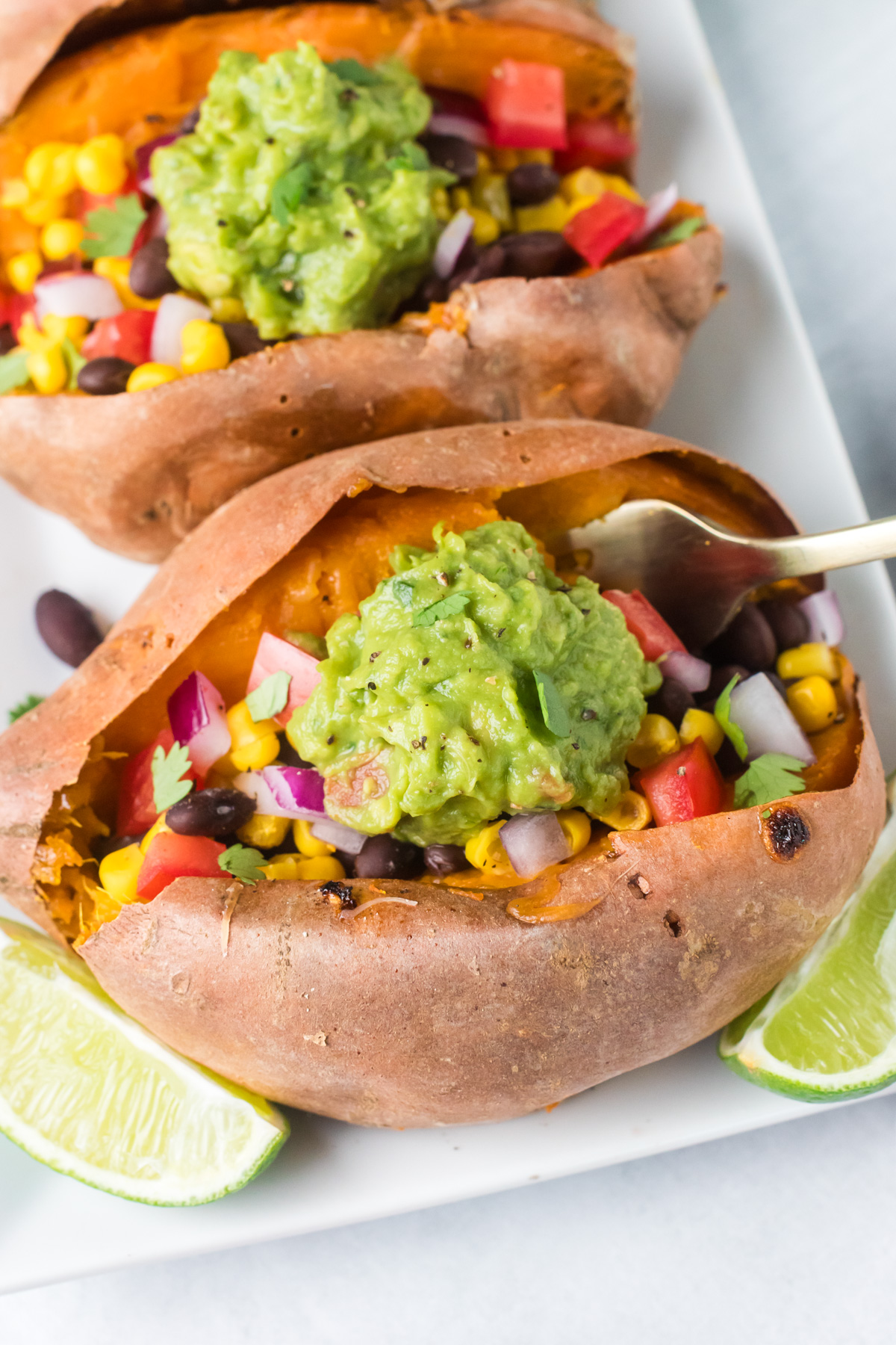 Black bean stuffed sweet potato with a fork.